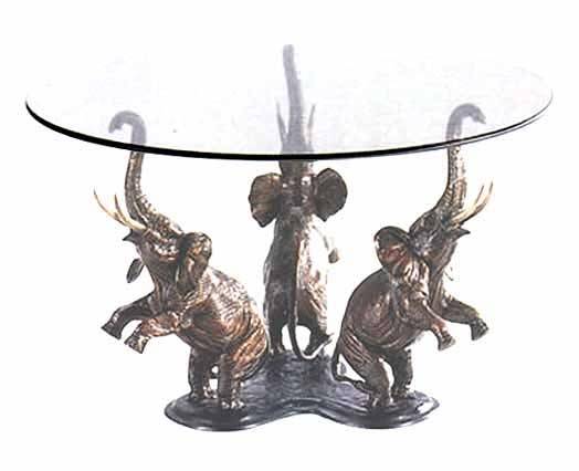 glass coffee table with elephant base. large glass and brass glass coffee table with elephant base. large glass and brass